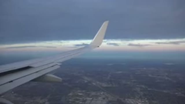PLAYA DEL CARMEN MEXICO-2015: Footage Of An Airplane Wing Flying Over City With Mackerel Sky