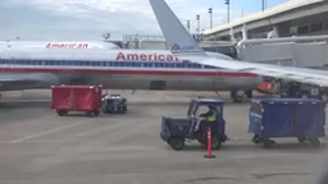PLAYA DEL CARMEN MEXICO-2015: Airport Worker Transports Baggage Across The Tarmac
