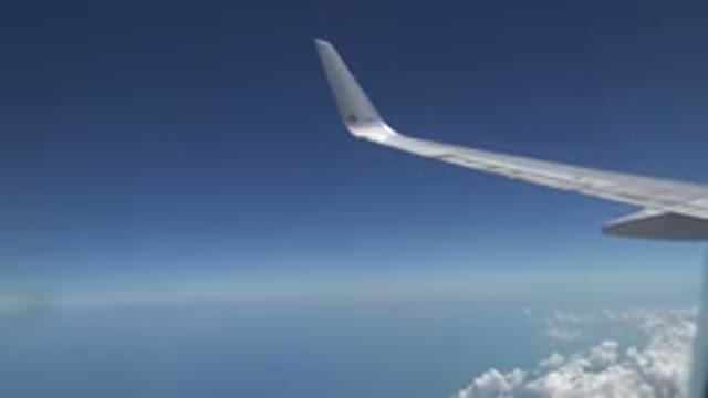 PLAYA DEL CARMEN MEXICO-2015: Background Of A Plane Flying Through The Clouds