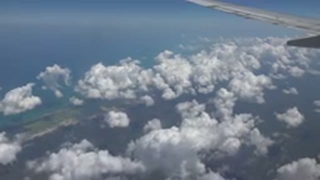 PLAYA DEL CARMEN MEXICO-2015: Passenger Airliner At Medium Altitude Above Clouds