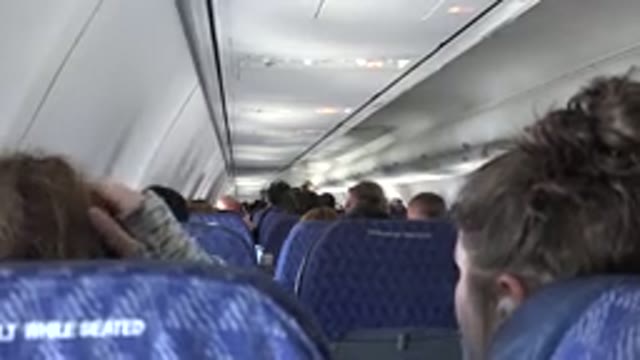 PLAYA DEL CARMEN MEXICO-2015: Woman On An Airplane Fixing Her Hair In The