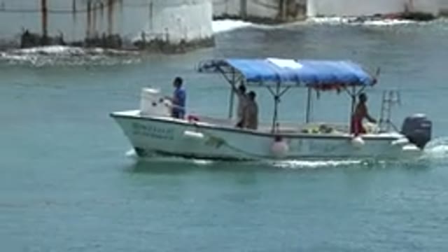 PLAYA DEL CARMEN MEXICO-2015: Four Men Enjoying The Warm Climate On A Boat