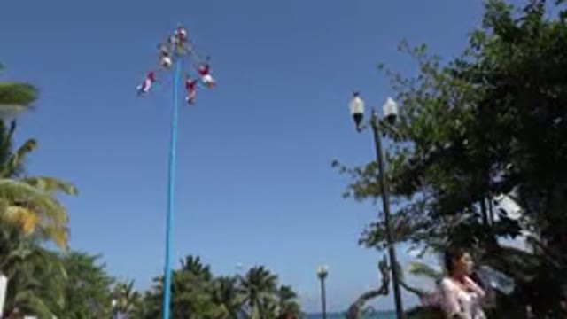 PLAYA DEL CARMEN MEXICO-2015: Circus Performer Practices Twirling Act on High Pole