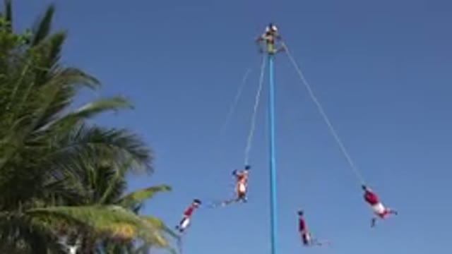 PLAYA DEL CARMEN MEXICO-2015: People Revolving Around A Pole Tied With A Rope