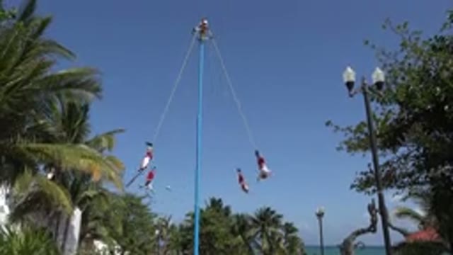 PLAYA DEL CARMEN MEXICO-2015: Group Of People Turning Upside Down In Playful Moment