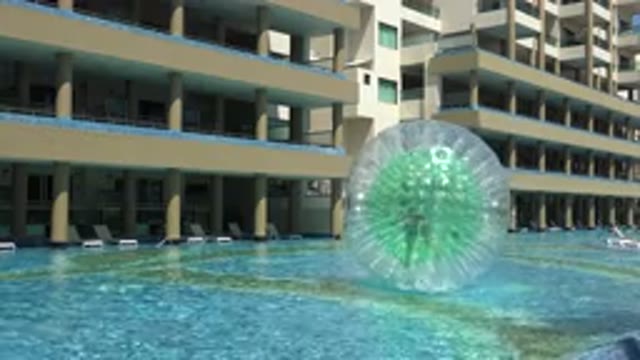 PLAYA DEL CARMEN MEXICO-2015: A Giant Ball Floating On Top Of A Pool Of Water