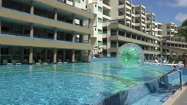 PLAYA DEL CARMEN MEXICO-2015: Person Playing Inside Plastic Ball In Hotel Pool