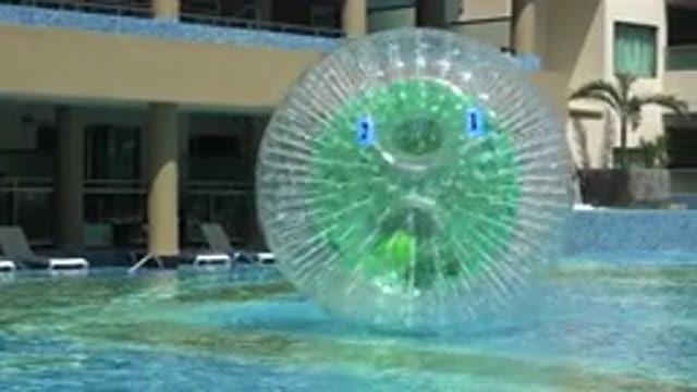 PLAYA DEL CARMEN MEXICO-2015: Boy Rolling In Giant Ball In Pool