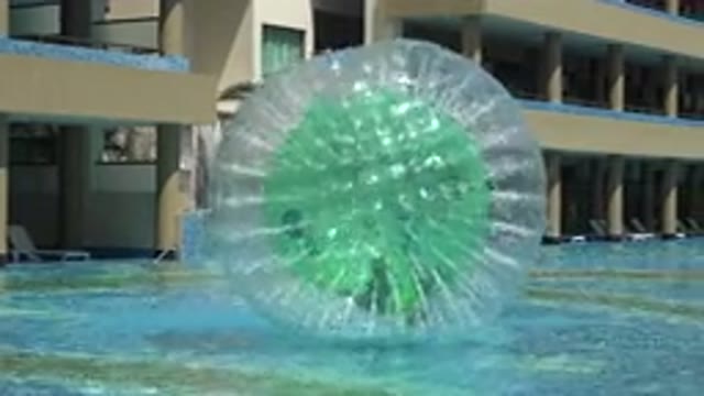 PLAYA DEL CARMEN MEXICO-2015: Person In A Plastic Ball Inside Water Enjoying The