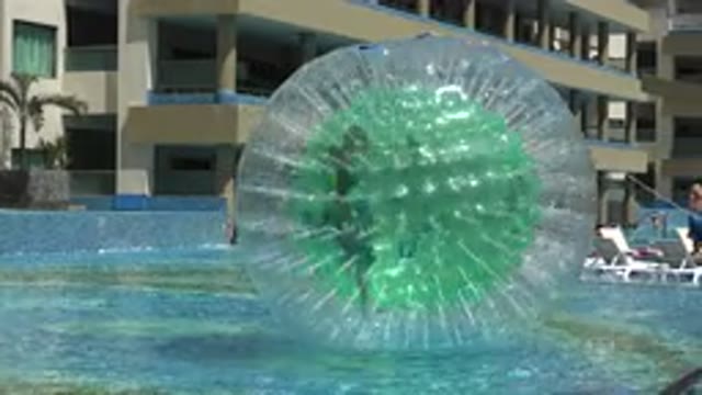 PLAYA DEL CARMEN MEXICO-2015: Child Playing Inside A Buoy In A Swimming Pool