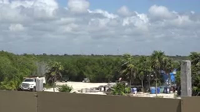 PLAYA DEL CARMEN MEXICO-2015: Rooftop View Overlooking Construction Site With Palm Trees