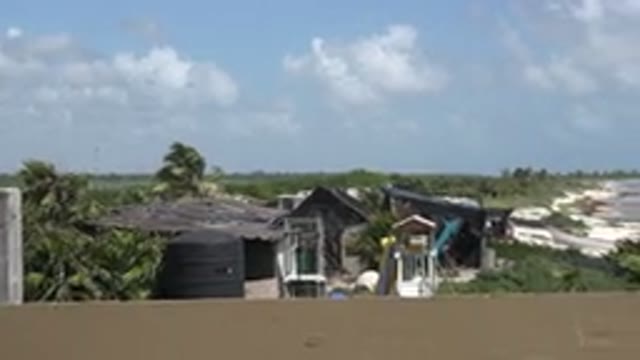 PLAYA DEL CARMEN MEXICO-2015: Beach And Ocean With Waves And Houses On The Shore