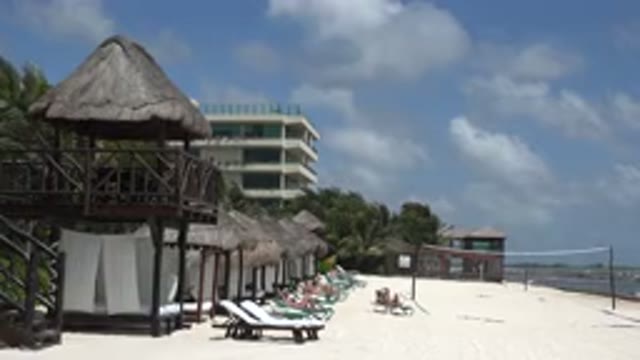PLAYA DEL CARMEN MEXICO-2015: A Brown Hut With Trees Around And A Blue Sky On A