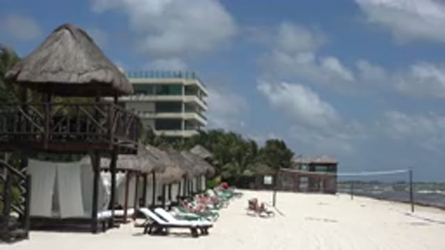 PLAYA DEL CARMEN MEXICO-2015: Beach With Buildings And Recreational Items On The Sand