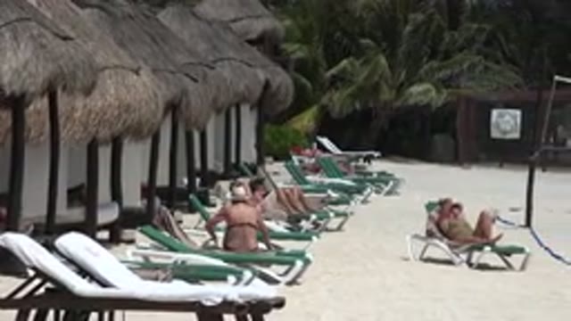 PLAYA DEL CARMEN MEXICO-2015: People On Vacation Sunbathing And Relaxing On The Beach