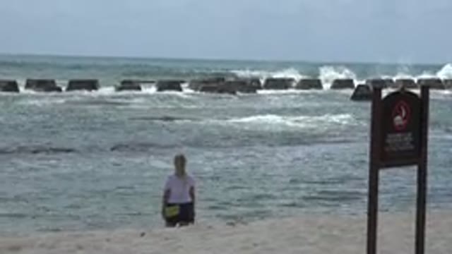 PLAYA DEL CARMEN MEXICO-2015: A Woman Staring At The Waves In A Sunny Day