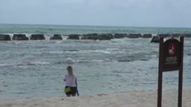 PLAYA DEL CARMEN MEXICO-2015: Woman Standing By The Shore With Waves Coming In