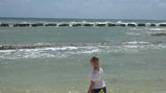PLAYA DEL CARMEN MEXICO-2015: A Woman Standing On A Beach Edge Looking At The