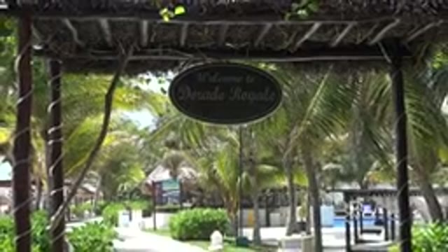 PLAYA DEL CARMEN MEXICO-2015: A Walkway Leading Up To A Building With Palm Trees