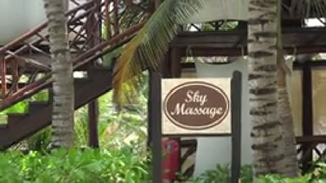 PLAYA DEL CARMEN MEXICO-2015: A Man And A Woman Walking In Front Of A Resort