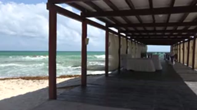 PLAYA DEL CARMEN MEXICO-2015: Cabana On The Ocean Shore With Waves Waving In