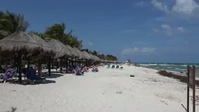 PLAYA DEL CARMEN MEXICO-2015: Shade Huts Lined Up On Beach Waves Roll In On