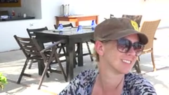 PLAYA DEL CARMEN MEXICO-2015: Mom Sitting At A Table At A Restaurant For Food