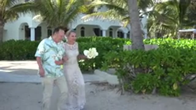 PLAYA DEL CARMEN MEXICO-2015: Just Married Couple Walking on Palm Beach