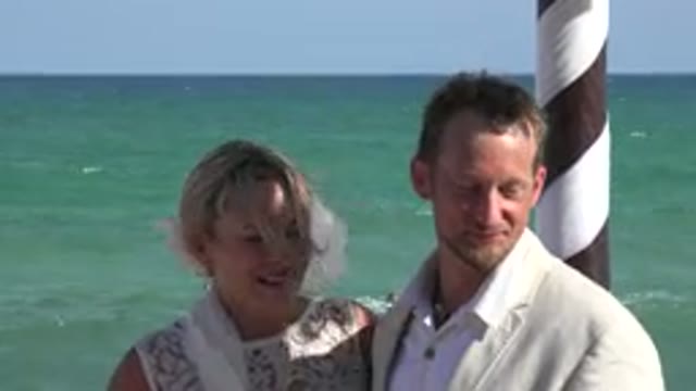 PLAYA DEL CARMEN MEXICO-2015: Couple Stands Near Blue Ocean Water And Brown Shoreline