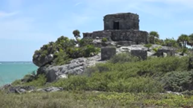 TULUM MEXICO-2015: A Small Old Castle Stands On The Rocks Beside The Sea