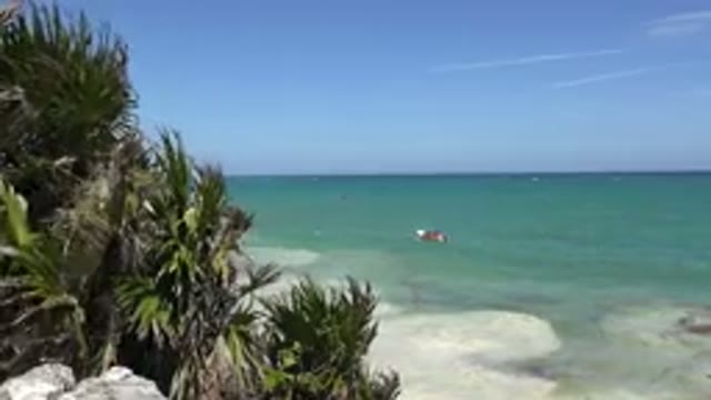 TULUM MEXICO-2015: Blue Ocean Water Tan Beach And Blue Sky On A Clear Day