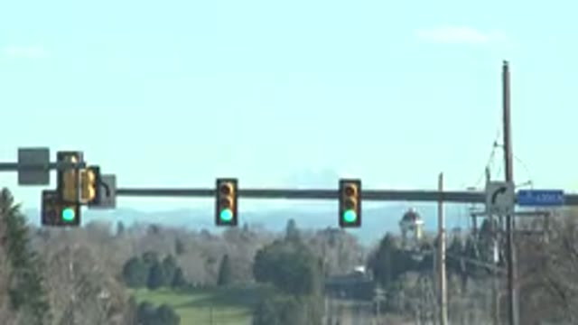 DENVER COLORADO-2015: Scene Of Cars Passing On The Road With Green Traffic Sign