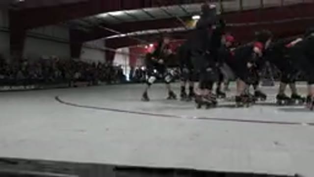 DENVER COLORADO-2015: People Wearing Black Shirts Skate On Red And White Indoor Rink