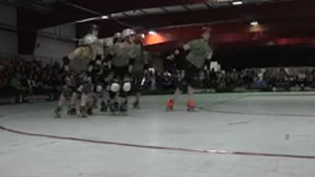DENVER COLORADO-2015: One Team Of Ladies In Green And Black Outfits Warm Up For Roller Derby Match