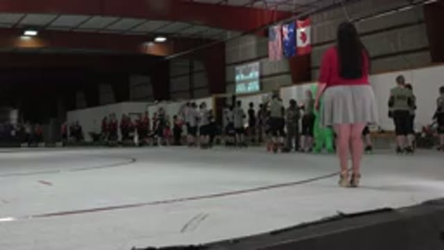 DENVER COLORADO-2015: People At A Roller Rink Standing In Salute To Their