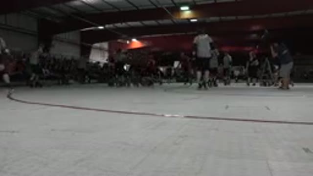 DENVER COLORADO-2015: Roller Derby Match Skaters And Referees Roll Around Rink