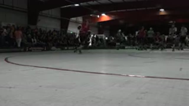 DENVER COLORADO-2015: Group Of People Skating In Gym With Crowd Watching From Bleachers