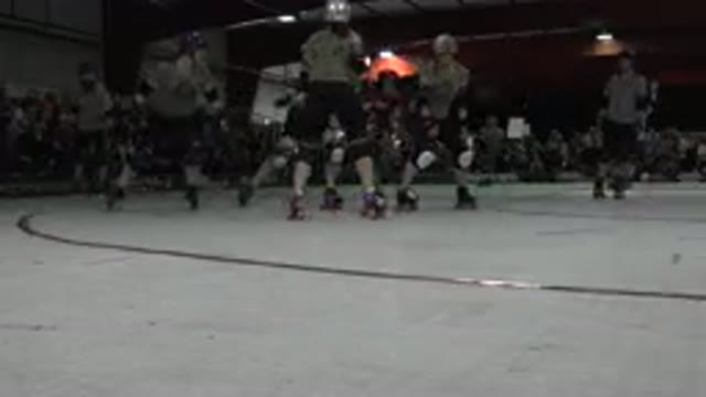 DENVER COLORADO-2015: Team Of Roller Derby Girls Roller Skating By Camera Beside