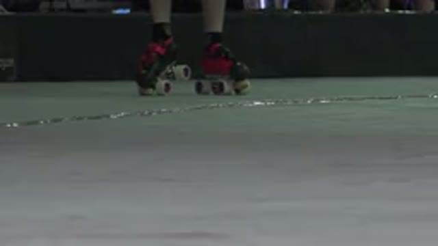 DENVER COLORADO-2015: Person Wearing Black And Red Roller Skates Stands On Pale Green Surface