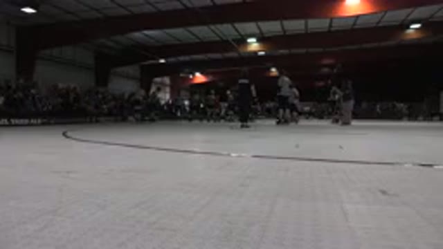 DENVER COLORADO-2015: Roller Derby Match Skaters And Referees On Rink Floor