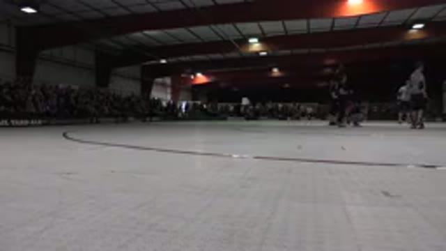 DENVER COLORADO-2015: Red And White Roller Rink With Referees Standing In Center