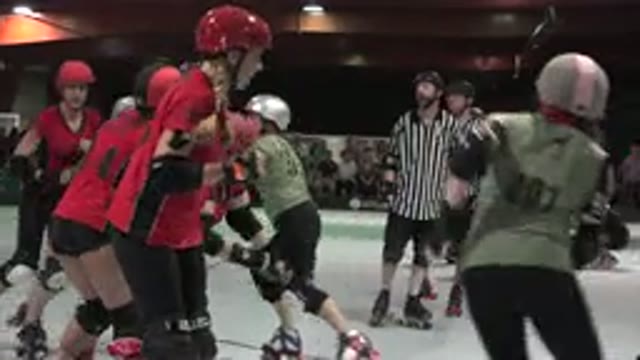 DENVER COLORADO-2015: Two Teams Of Roller Skaters Playing In Arena With Referee