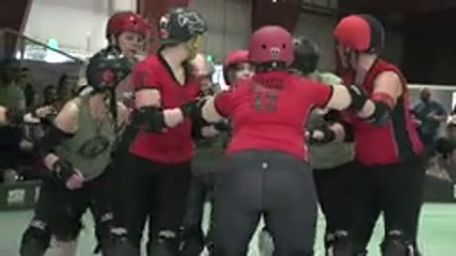 DENVER COLORADO-2015: Roller Derby Skaters Pushing Each Other During Match