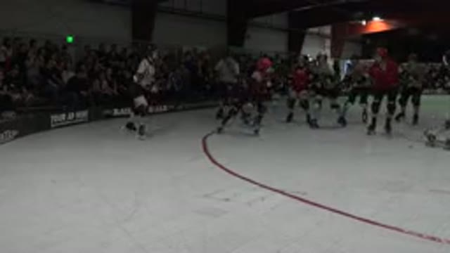 DENVER COLORADO-2015: Roller Derby Match Skaters And Referees Move Around Rink