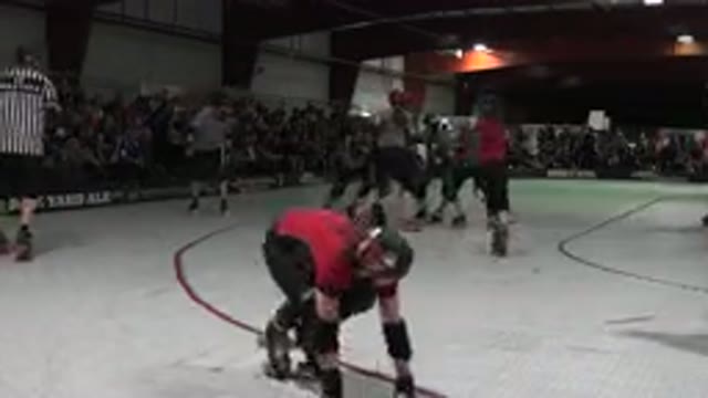DENVER COLORADO-2015: Roller Derby Skaters Pushing Each Other On White Rink
