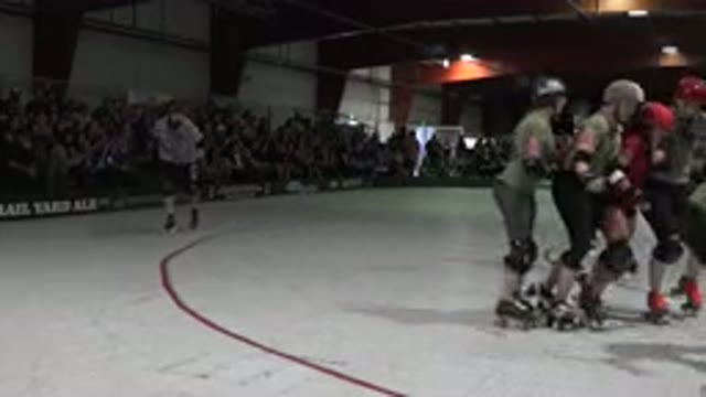 DENVER COLORADO-2015: Roller Derby Match Skaters Roll Around Rink Referee Rolls