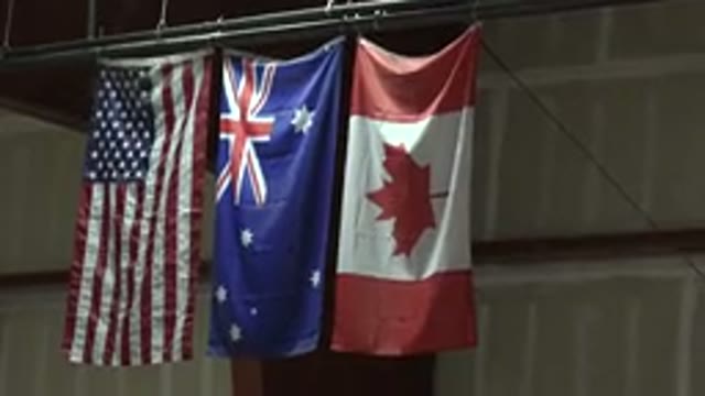 DENVER COLORADO-2015: Three Flags Of The United States Australia And Canada Are Raised Vertically