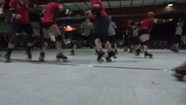 DENVER COLORADO-2015: Roller Derby Match Skaters Roll Around One Skater Falls