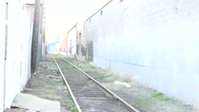 DENVER COLORADO-2015: Empty Train Tracks Running Between Multi Colored Brick Buildings