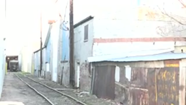 DENVER COLORADO-2015: Trolley Car Travels Through An Alleyway